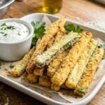 Crispy baked zucchini fries coated with Parmesan cheese and golden breadcrumbs served with dipping sauce